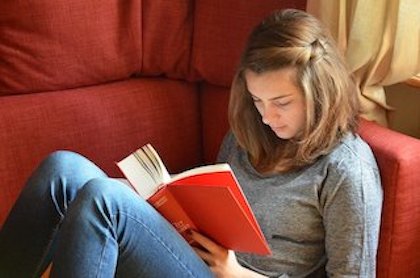 Girl Reading On Couch